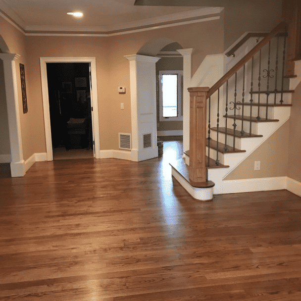 A spacious foyer with wood floors with walls painted in relaxed khaki sw 6149 by @joni.