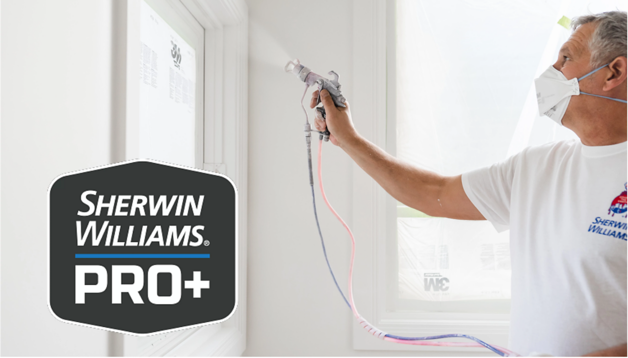 A person with a Sherwin-Williams t-shirt on wearing a mask while spraying paint on a wall. Sherwin-Williams PRO Plus logo.