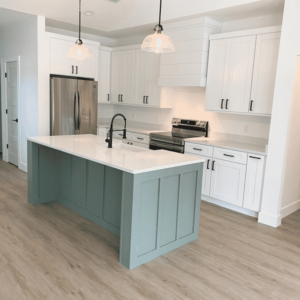 A kitchen island painted in studio blue green sw 0047 by @b_p_designco.