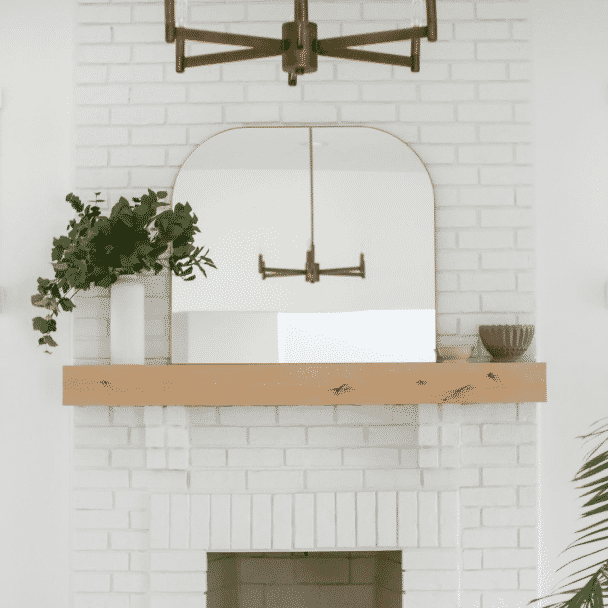 A brick fire place painted in pure white sw 7005 by @elabobak.