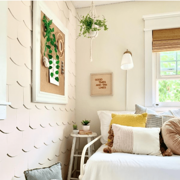 A bedroom with a scalloped textured accent wall by @comfortandgracehomedesign.