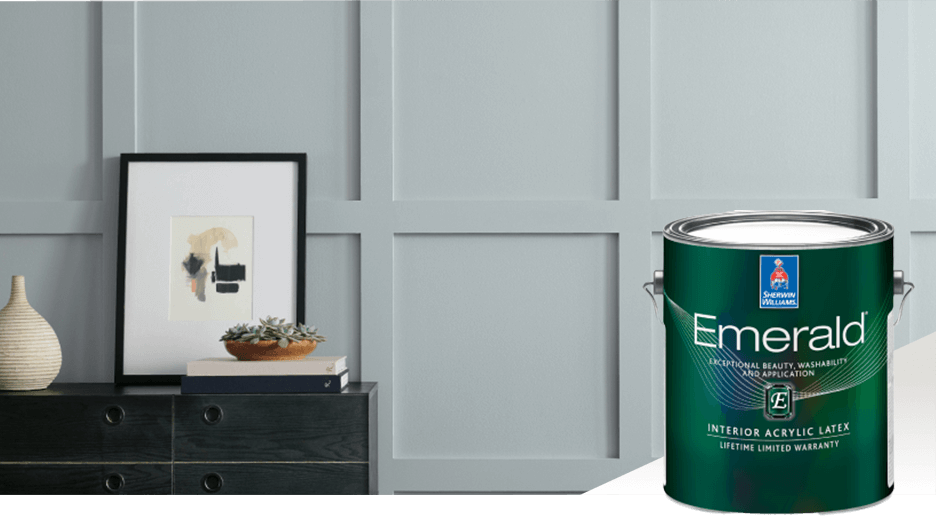 A dark colored sideboard with a picture and vase against a bluish gray wall. Emerald interior acrylic latex.