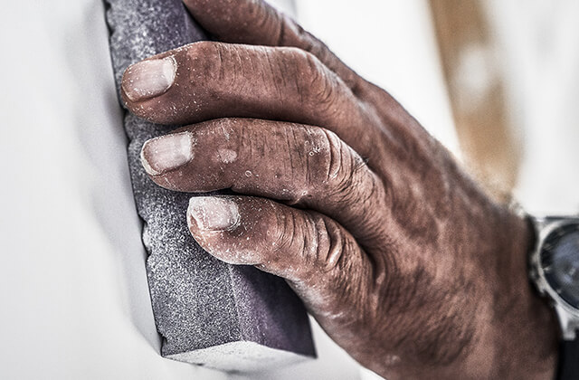 Hand holding 3M Pro Grade Sanding Block.