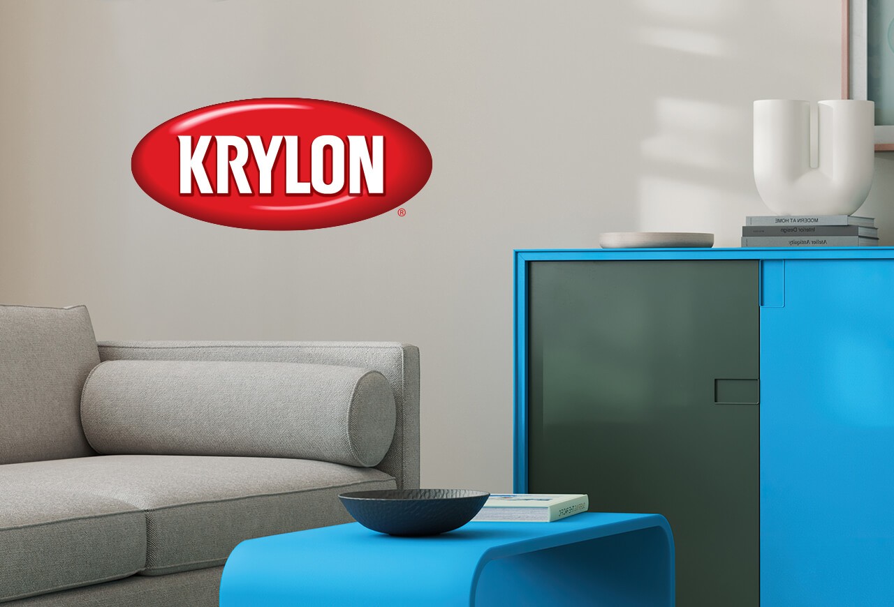 Krylon. A living room with a gray sofa and modern table and cabinet painted blue.