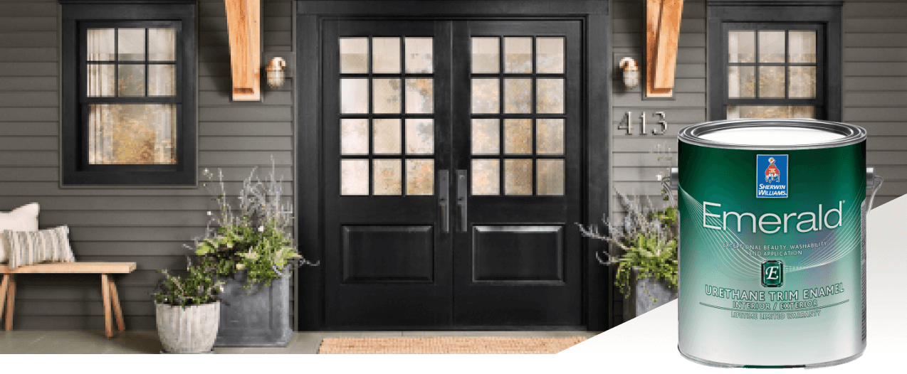 The exterior of a home with black doors with square glass windows and siding painted in dark gray. Product featured Emerald Urethane Trim Enamel.