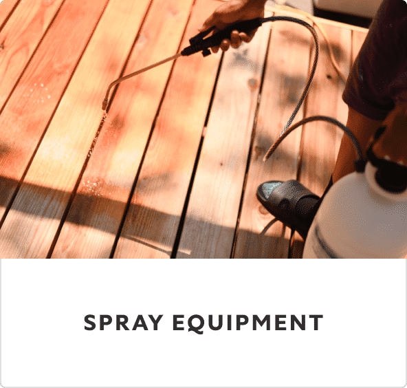 A person spraying a wood deck.