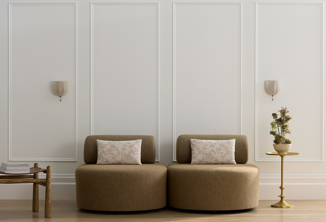 Two accent chairs against a bright wall.