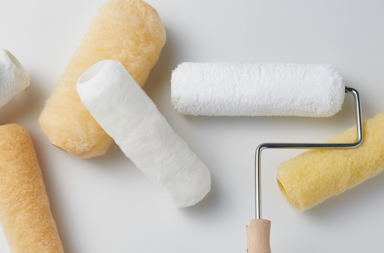 Roller covers and rollers on drop cloth.
