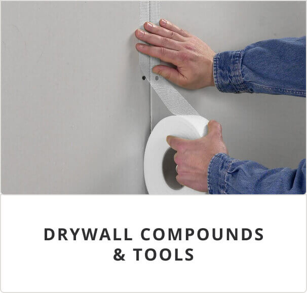 Drywall Compounds and Tools. A person taping off a corner of a wall.