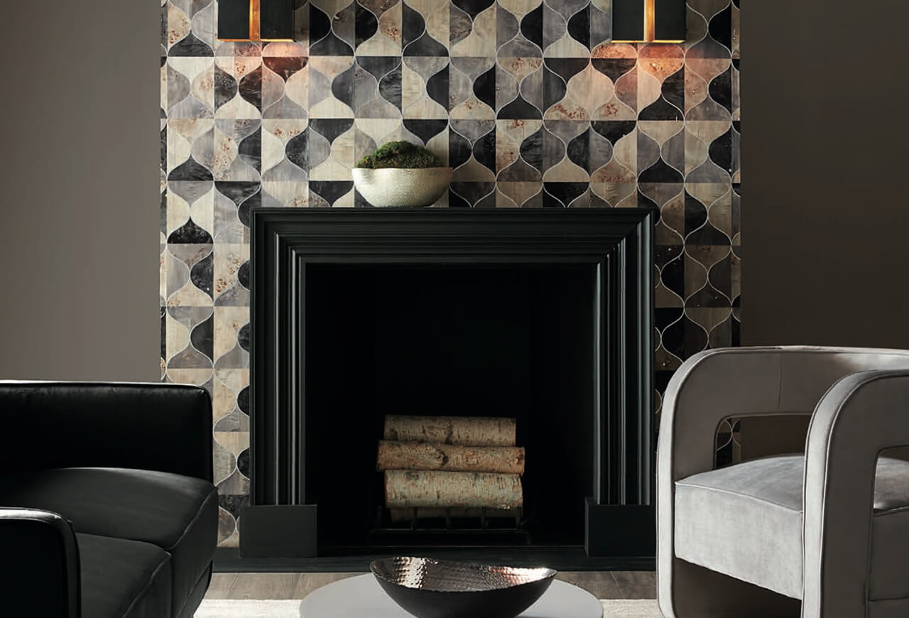 A dark seating area around a black fireplace with a geometric tile surround.