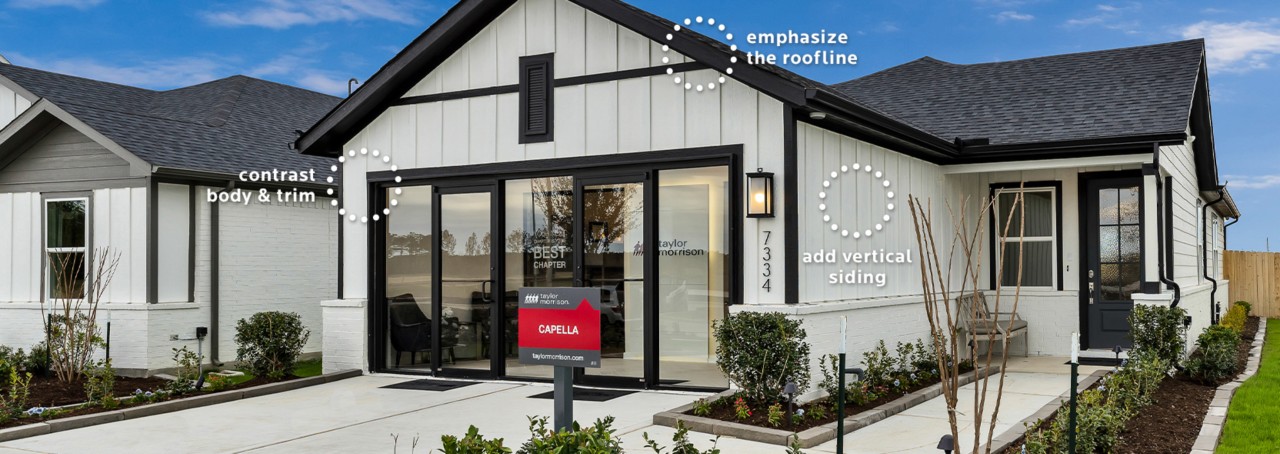 Home exterior with contrasting Pure White painted vertical siding and black Caviar trim, windows, and sliding glass front entry doors.