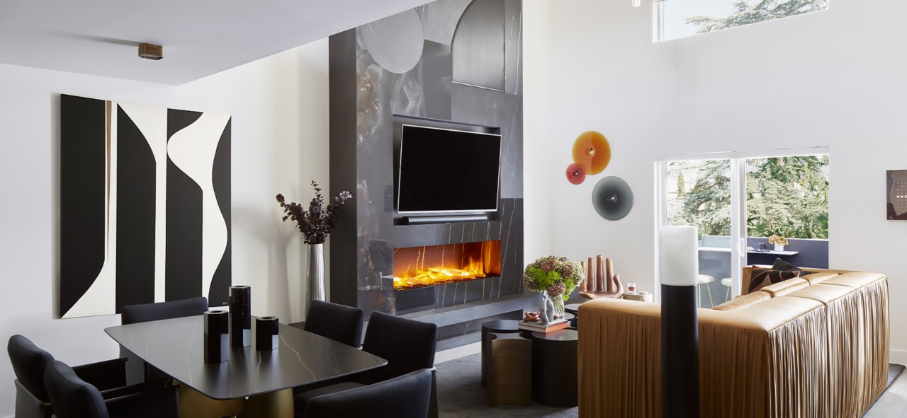 Modern living room and dining area with high ceilings, white walls, abstract artwork and modern fireplace and TV as focal point.