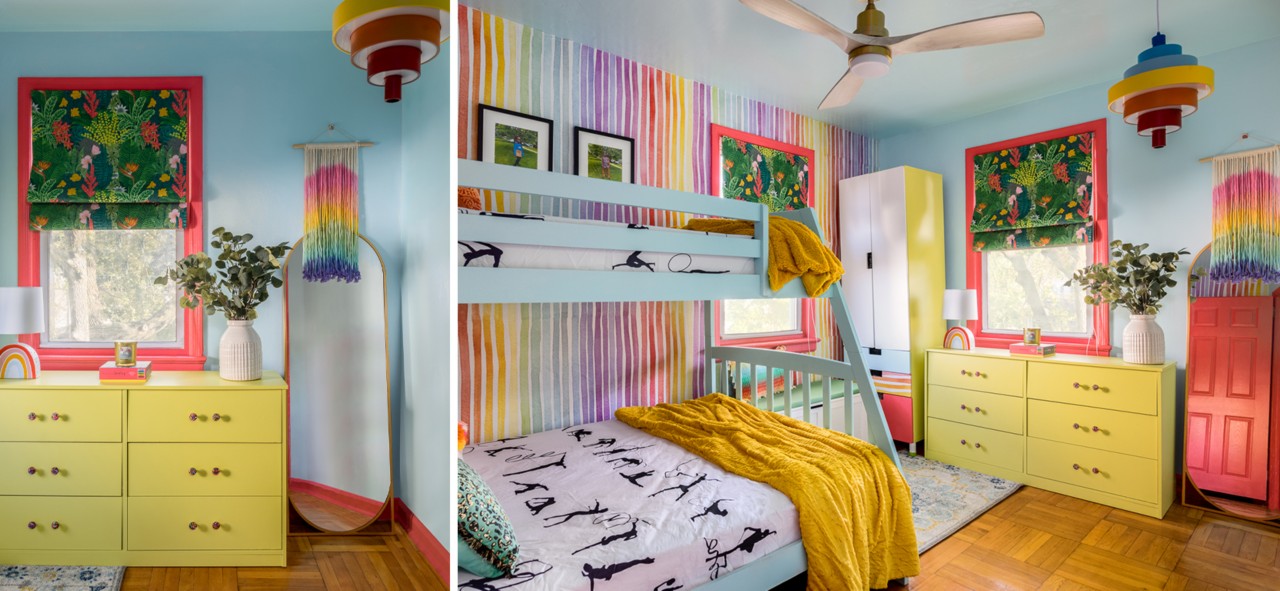 A colorful child’s room with light blue walls and bunk bed, yellow-green dresser and wardrobe, rainbow accent wall and details, and wood floor.