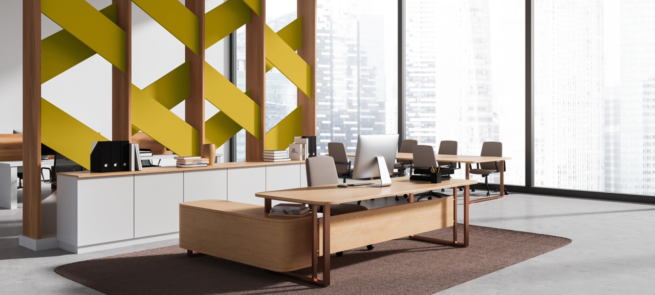 Office space with high ceilings, view over an urban cityscape, and an accent partition using Kingdom Gold.