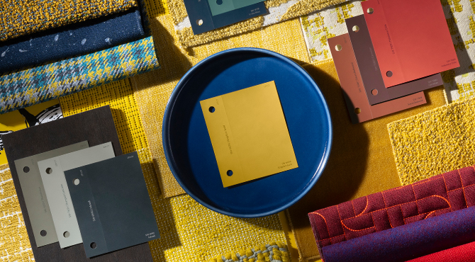 Flat lay of paint chips from The Loneliest Color™ by Sherwin-Williams x Dapper Dan Color Collection displayed with other coordinating fabrics and material swatches.