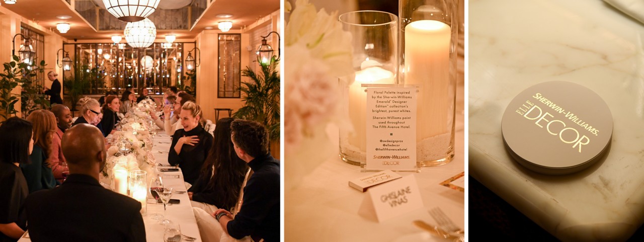 Long table with white place settings and candle centerpieces in a cozy and warmly lit room.