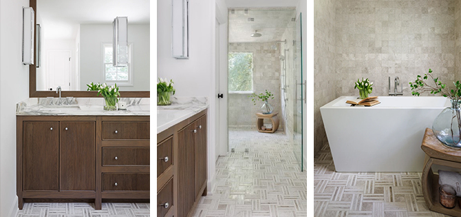 Bathroom with large vanity mirror over wood cabinetry, white walls and marble countertop and modern free-standing white bathtub in fully tiled niche.