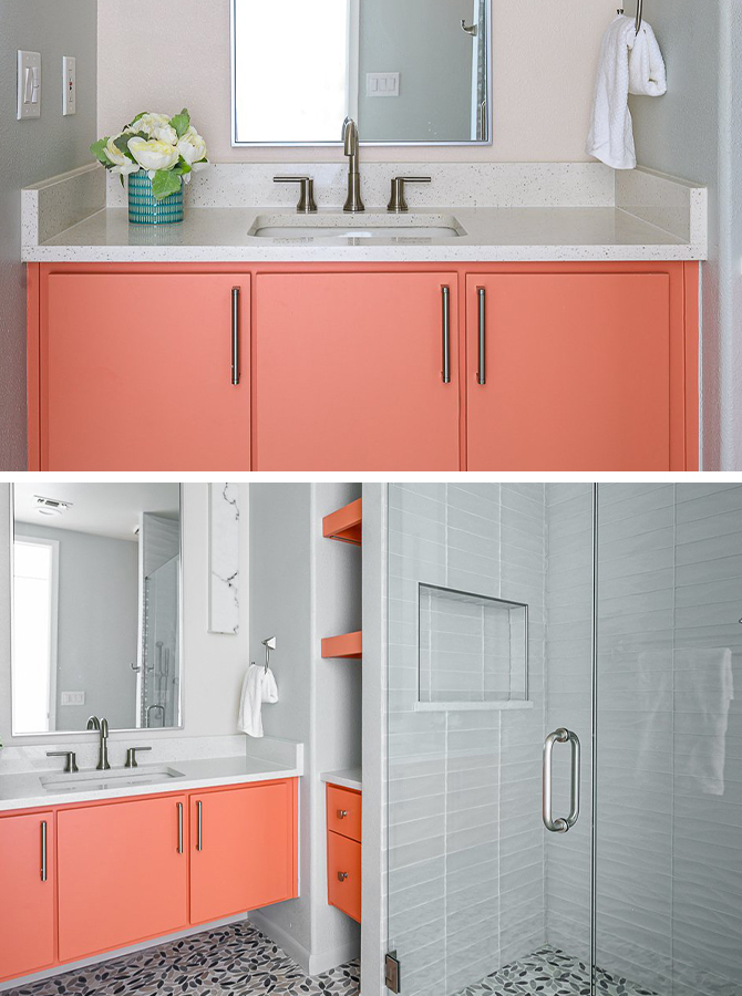 Bathroom with neutral gray color scheme and bright coral-colored vanity cabinets near a glassed-in shower.