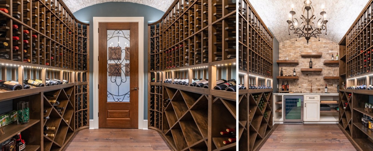 Large wine cellar with arched ceiling, exposed brick, warm woods and a chandelier.
