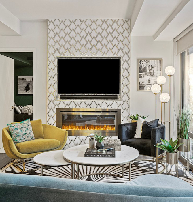 Stylish living room with TV, electric fireplace, and modern furniture featuring a geometric patterned accent wall, surrounding walls painted Sherwin-Williams Pure White, and large windows.