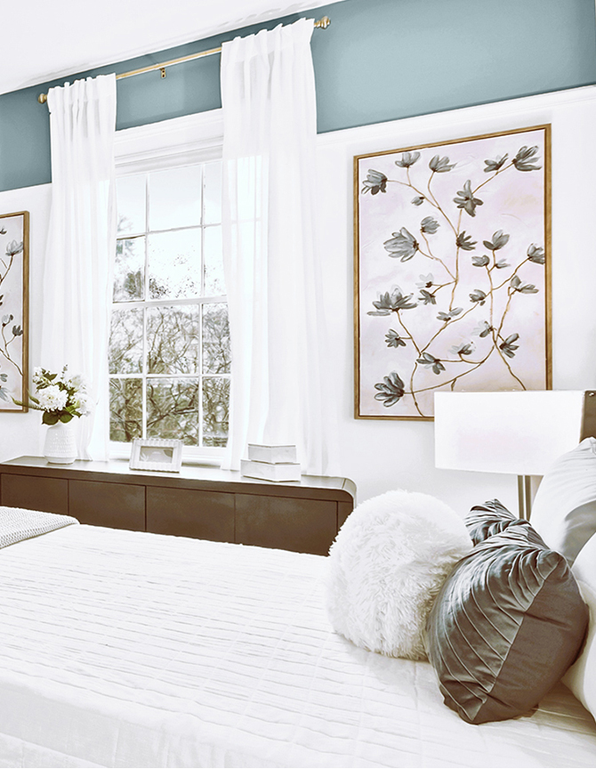 Bedroom with a white bedspread, fireplace, large window, and decorative accents in blue and wBedroom with a white bedspread, fireplace, large window, and decorative accents in blue and white, featuring Sherwin-Williams Morning at Sea and Stargazer.hite, featuring Sherwin-Williams Morning at Sea and Stargazer.