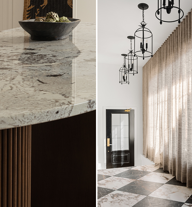 Close-up of the curved kitchen island countertop with a bowl and a room with lantern-style pendant lights, floor-to-ceiling curtains, and marble tile flooring bathed in natural light.