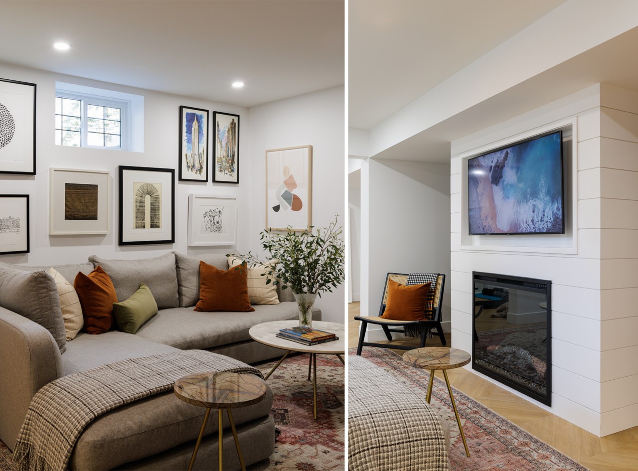 A basement living room with a gray sectional sofa, framed art, and a wall-mounted TV above a fireplace.