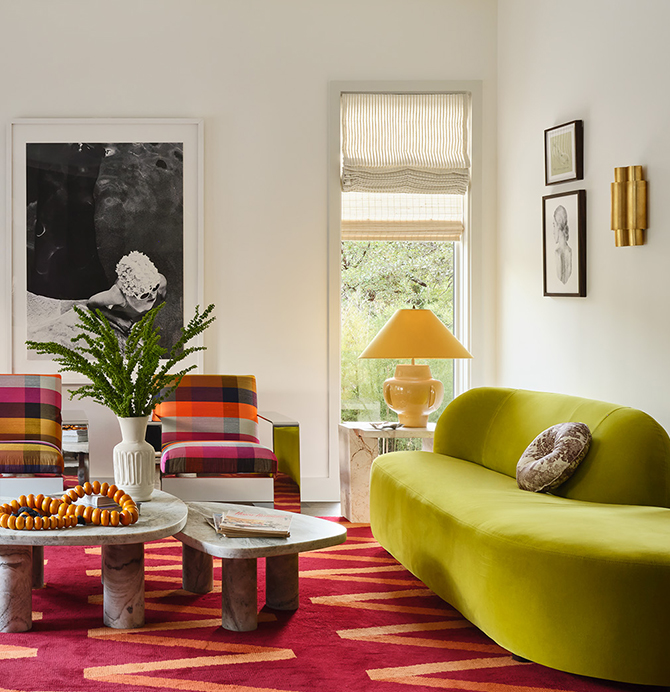 A colorful, modern living room with a lime green sofa, plaid chairs, and a red patterned carpet, featuring eclectic decorations against a backdrop of White Snow painted walls.