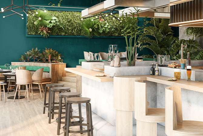A restaurant with many plants and bar stools.