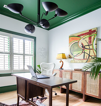 An office with a desk and white walls with a green ceiling and window trim painted with SW 6446 Arugula.