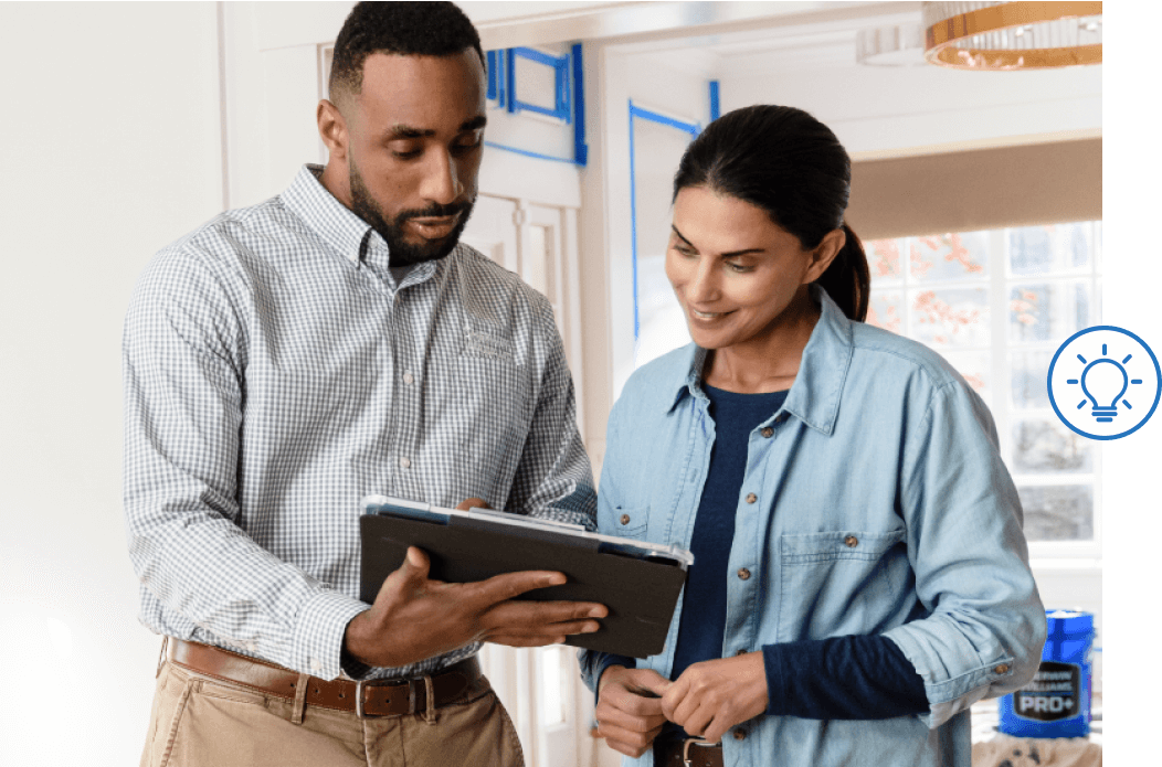 Two people looking at a tablet.