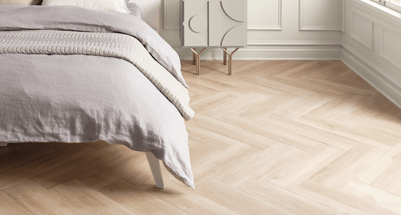 A bedroom with wood floors and white wainscotting.
