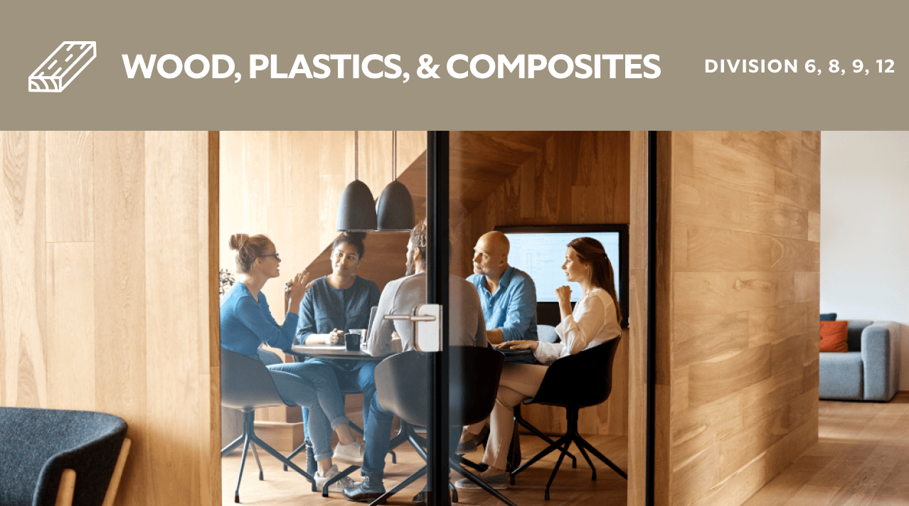 Wood, plastics, and composites. Division 6, 8, 9, 12. A group of people siting in a wood paneled meeting room.