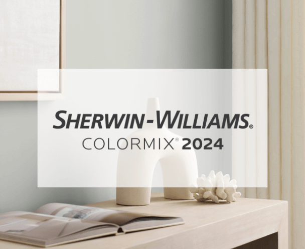 Sherwin-Williams Colormix® 2024. A light gray wall behind a console table holding an open book and modern decor.