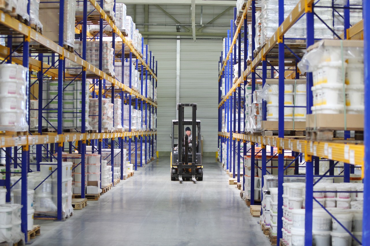 Man works on loader machine at factory