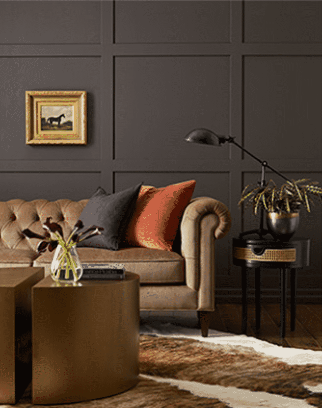 Dark gray walls with bronze couch, table and side table.