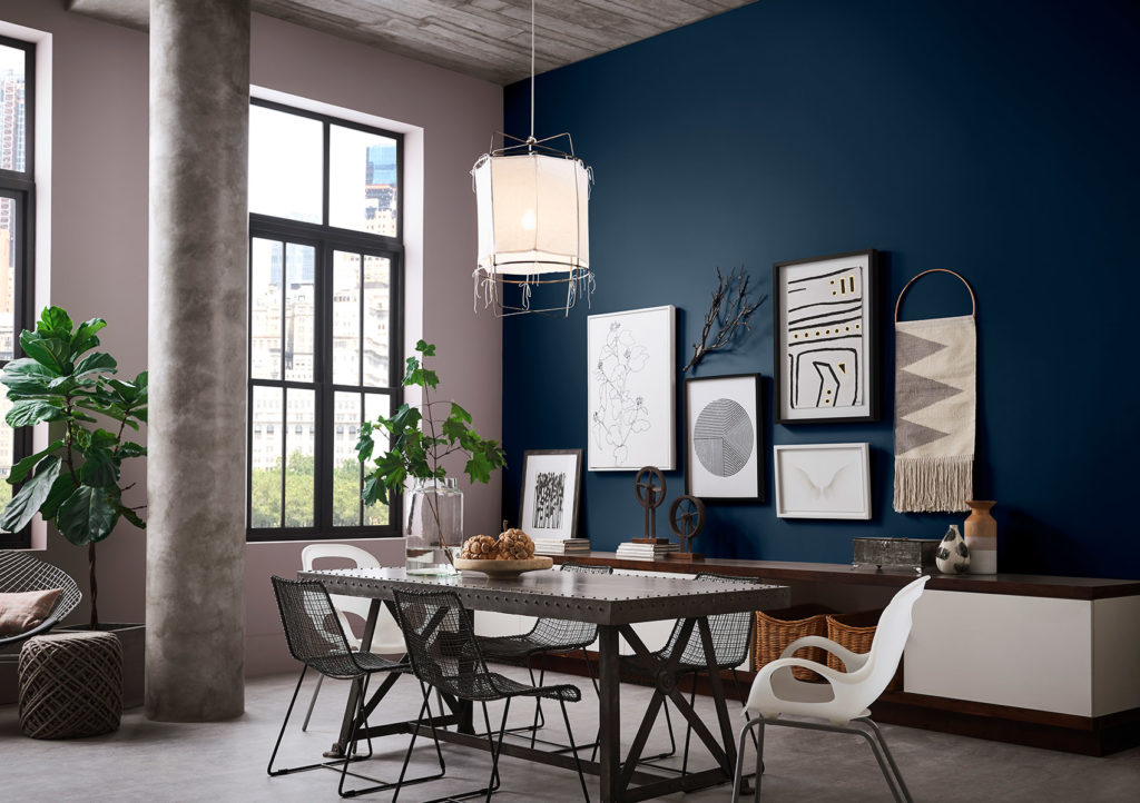 Modern office with Sherwin Williams 2020 Color of the Year Naval SW 6244 colored walls and abstract wall art. 