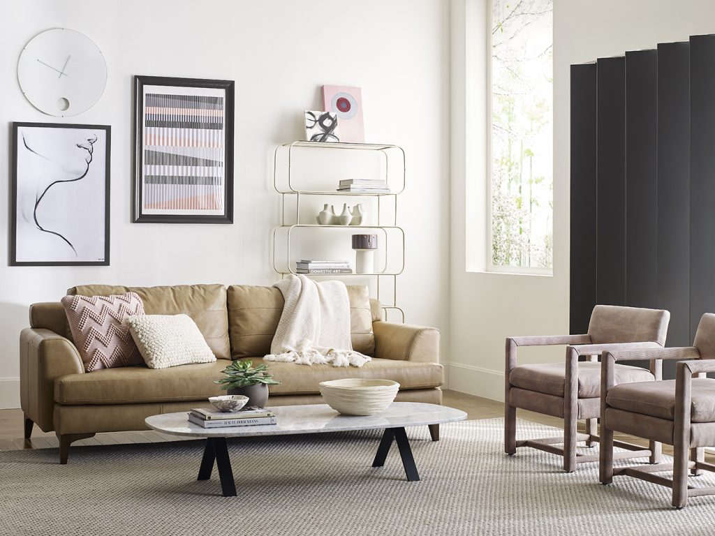 Contemporary living room with SW 9583 Sanctuary colored walls with SW 7048 Urbane Bronze accents, cozy leather couch, marble coffee table, and chairs. 