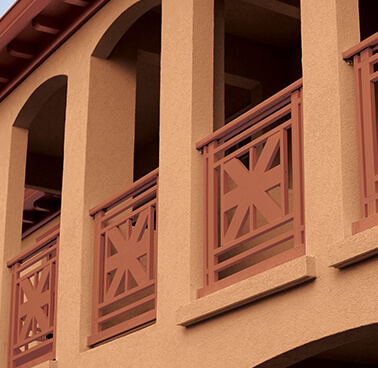 An exterior home balcony with warm paint colors.