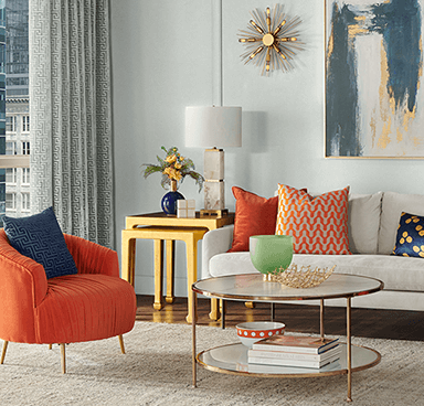 A retro living room with orange chair, and netural couch and wall