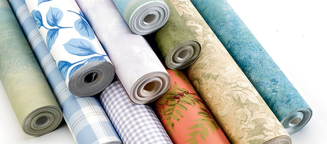 Five rolls of different patterned wallpaper.