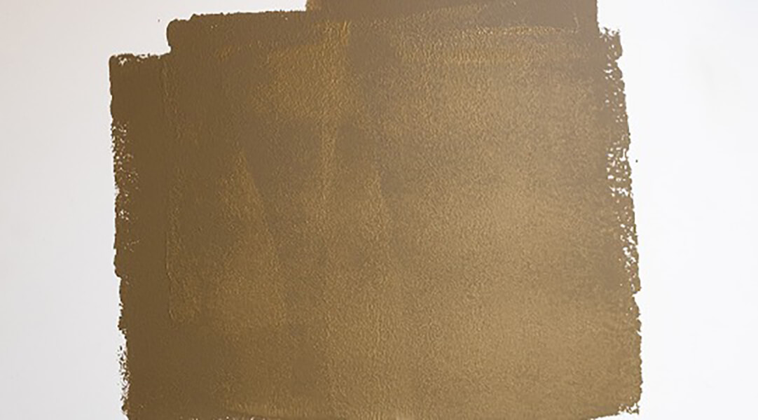 A wet paint blotch on a white wall. SW color featured: SW 9124 Verde Marron.