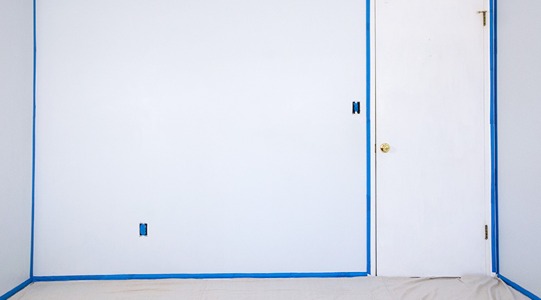 A white wall with masking tape. 
