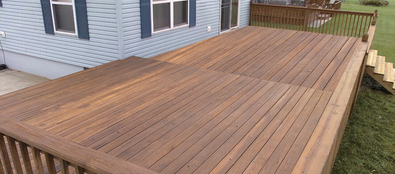 A backyard deck that has been newly cleaned and stained.